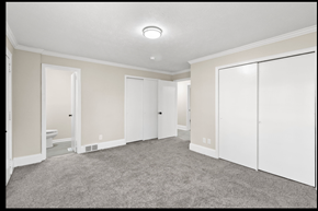 Fayetteville house for rent - A spacious room with white doors and carpeted floor.