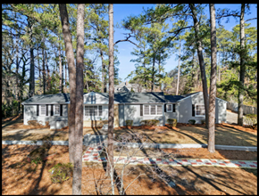 Fayetteville house for rent - A house surrounded by trees in a sunny day.