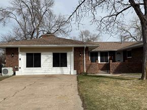 Fort Collins apartment for rent - A house with a white garage door and a brick wall.