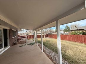 Fort Collins apartment for rent - A patio with a white roof and a red fence.