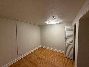 Fort Collins apartment for rent - A room with a light on the ceiling and a wooden floor.
