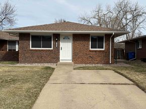 Fort Collins apartment for rent - A brick house with a white door and a small porch.