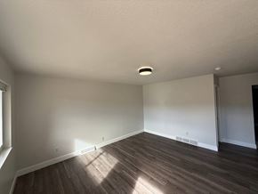 Fort Collins apartment for rent - A room with wooden flooring and white walls.