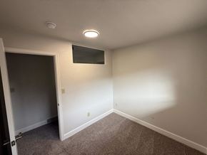 Fort Collins apartment for rent - A room with a carpeted floor and a small window on the wall.