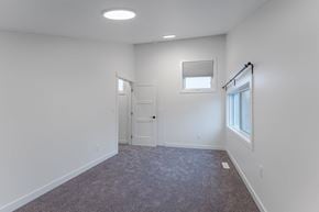 Edmonton apartment for rent - A room with a carpeted floor and a window with blinds.