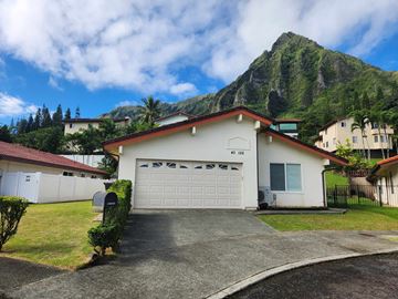 Kaneohe house for rent - A house with a mountain in the background.