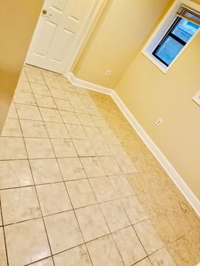 Washington apartment for rent - A hallway with a tiled floor and a white door.
