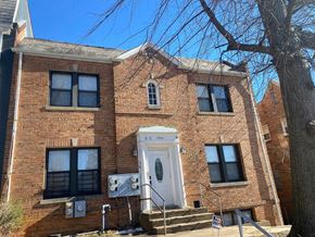 Washington apartment for rent - A brick building with a white door and windows.