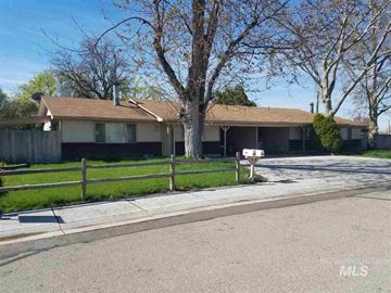 Boise apartment for rent - A house with a brown roof and a white fence is shown.