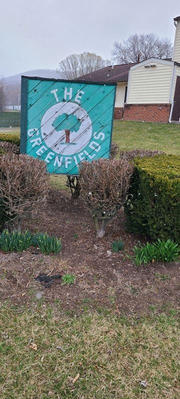Claysburg apartment for rent - A sign that says "The Greenfields" is in front of a house.