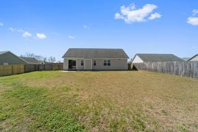 Richlands house for rent - A large grassy field with a house and a fence in the background.