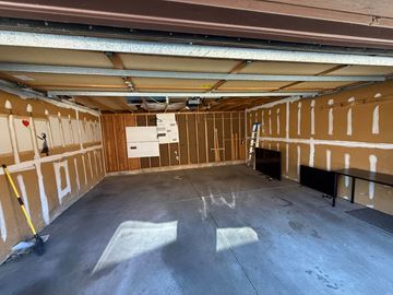 Boulder apartment for rent - A spacious garage with a concrete floor and walls covered in insulation.