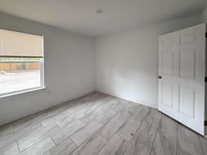 San Antonio apartment for rent - A room with a white door and a window with blinds.