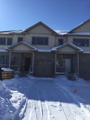 Kingston house for rent - A house with a snow-covered front yard.