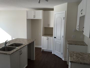 Kingston house for rent - A kitchen with a sink and cabinets.