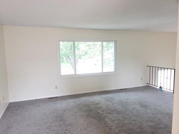 Coon Rapids house for rent - A room with a carpeted floor and a window.