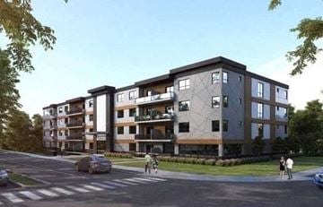 London apartment for rent - A modern apartment building with balconies and a street in front.