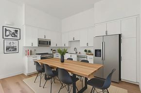 Moorpark apartment for rent - A modern kitchen with a wooden table and black chairs.