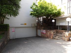 Dallas apartment for rent - A white garage door with a red sign on it.