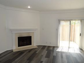 Dallas apartment for rent - A room with a fireplace and sliding glass doors.