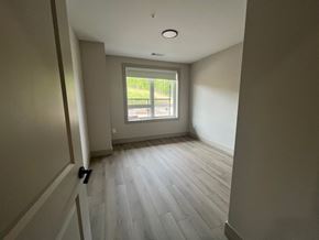 Dartmouth apartment for rent - A room with a window and a wooden floor.