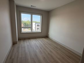 Dartmouth apartment for rent - A room with a window overlooking a cityscape.