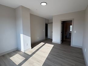 Dartmouth apartment for rent - A room with a light on the ceiling and a doorway leading to another room.