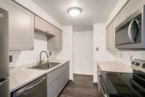 Denver apartment for rent - A kitchen with a sink, stove, and microwave.