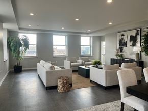 Tulsa apartment for rent - A living room with a grey floor and white furniture.