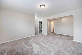 Kimberly house for rent - A spacious room with a carpeted floor and a ceiling light.