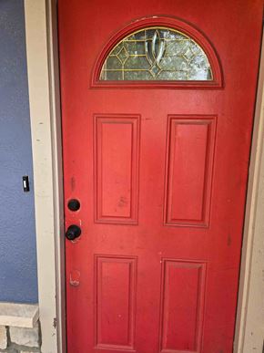 Brownsville house for rent - A red door with a glass window above it.