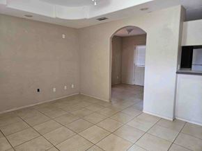 Brownsville house for rent - A spacious room with beige walls and tiled flooring.