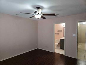 Brownsville house for rent - A room with a ceiling fan and a toilet in the corner.