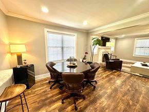 Greenville house for rent - A conference room with a table, chairs, and a television.