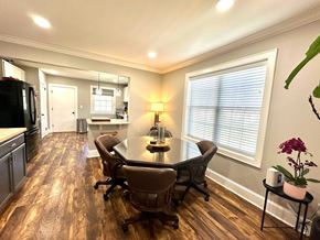 Greenville house for rent - A kitchen with a table and chairs in the middle of the room.