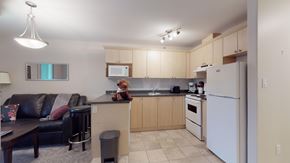 Fort Mcmurray house for rent - A kitchen with a white refrigerator and a teddy bear on the counter.