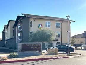 El Paso apartment for rent - Gonzalez Place apartment complex with a car parked in front.