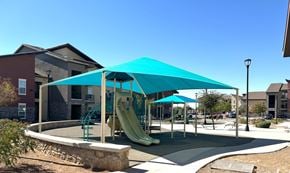 El Paso apartment for rent - A playground with a blue canopy and a yellow slide.