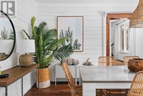 Lake Of Bays (Sinclair) house for rent - A bedroom with a large bed and a small nightstand.