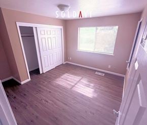 Merced house for rent - A room with wooden flooring and a white door is for sale.