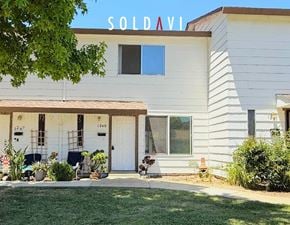 Merced house for rent - A white house with a blue sign that says "SOLD AVAILABLE" on the top.