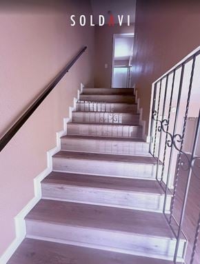 Merced house for rent - A staircase with a sold sign on the wall.
