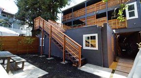Berkeley apartment for rent - A wooden staircase leads to a balcony on the second floor of a modern house.