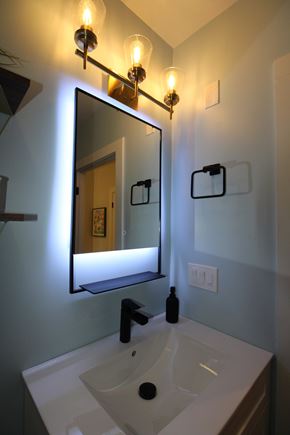Berkeley apartment for rent - A bathroom with a sink, mirror and light fixture.