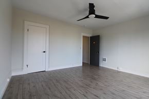 Berkeley apartment for rent - A room with a ceiling fan and wooden flooring.