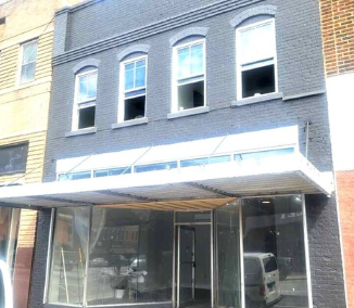 Roanoke Rapids apartment for rent - A building with a grey facade and a white awning.
