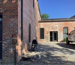 Halifax apartment for rent - A white car is parked in front of a brick building.