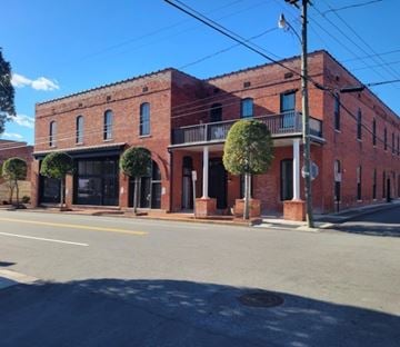 Halifax apartment for rent - A red brick building with a black awning and a tree in front.