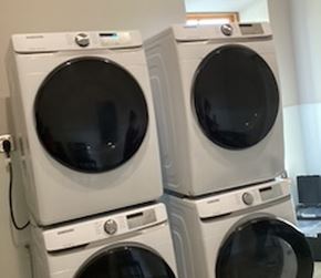 Halifax apartment for rent - Three white front loading washing machines stacked on top of each other.