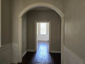 Warrenton apartment for rent - A white door is at the end of a hallway.